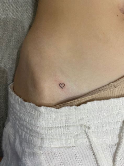 Tiny heart tattoo on hip Heart On Hip Tattoo Simple, Tiny Bone Tattoo, Pelvic Tattoo Hip Small Heart, Single Needle Hip Tattoo, Small Tattoos For Hip, Tattoo Ideas Female Cool, Subtle Heart Tattoo, Stick And Poke On Hip, Dainty Tattoos Ribs