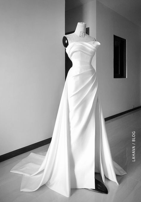 Minimalist wedding dress is always a different choice for brides who love simplicity, classic, and elegance. While the gorgeous beaded princess wedding gowns, the minimalist wedding dress focuses mainly on the silhouettes. Delicate draping and high-quality materials have made many brides fall in love with this style. As a minimalist bride, you'll likely be drawn to simple and classic silhouettes like pared-back slip dresses, unadorned ball gowns, and courthouse-chic mini dresses. Or perhaps you Draped Bridal Gown, Wedding Dresses Minimalist, Minimalist Bridal Gown, Minimalist Wedding Gown, Tailored Wedding Dress, Draping Dress, Weddding Dress, Minimalist Gown, Minimalist Wedding Dress