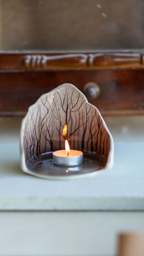 Step into a world of enchantment with our Enchanted Forest Tea Light Holder. Handcrafted with care, this ceramic candle holder brings the rustic beauty of the woods into your home. The forest-inspired design, featuring delicate trees and woodland details, adds a touch of magic to your decor. It also makes a thoughtful gift for friends and family who appreciate the beauty of the great outdoors.🌲✨ Tea Light Ceramic, Forest Ceramics, Pottery Tea Light Holders, Ceramic Holder, Handcrafted Gifts, Tea Lights Ideas, Diy Clay Gifts Ideas, Ceramics Gift Ideas, Ceramic Tea Light Holders