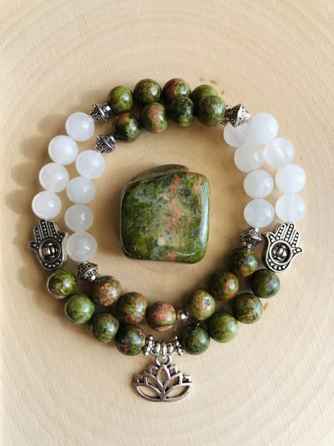 Beautiful genuine Unakite and Clear Quartz double wrap 8mm beaded gemstone bracelet, uniquely adorned with a silver Lotus charm, silver Hamsa charms, and small silver accents.  Made with 1mm elastic cord, this double wrap bracelet measures 16 inches and can stretch to fit most wrists. Handmade with love and healing energy in Franklin, Tennessee! Connect with me on Instagram! @cosmicmoonfairyjewelry Gemstone Bracelet Ideas, Gemstone Bracelets Ideas, Crystal Bracelet Ideas, 8mm Beaded Bracelets, Unakite Bracelet, Handmade Jewelry Ideas, Stretch Beaded Bracelets Diy, Love And Healing, Double Bracelet