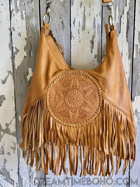 Show your unique style with our incredible Mandala Convertible 2 way Backpack to Crossbody Fringed Boho Bag! Crafted with exquisite, supple genuine leather, this stunning bag boasts a hand tooled mandala center and gorgeous fringe detailing. This bohemian dream is an absolute must-have! Handmade with love Genuine Leather Zip Close Inside bag- Zip pocket and 2 open pockets Lined Hand tooled Mandala feature Measurements - Approx W39cm x H35cm Colours: Black, Brown & Tan Please keep in mind that le Bohemian Style Bag, Boho Market, Boho Chic Bags, Western Handbags, Western Purses, Inside Bag, Stylish Handbags, Fringe Bags, Gold Bag