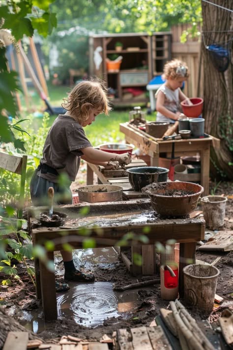 Children playing with mud and water at outdoor activity tables in a garden setting. Ways To Arrange Living Room, Arrange Living Room Furniture, Kids Garden Play Area, High Ceiling Chandelier, Mud Kitchen Ideas, Outdoor Play Kitchen, Kids Garden Play, Mud Kitchen For Kids, Kitchen For Kids