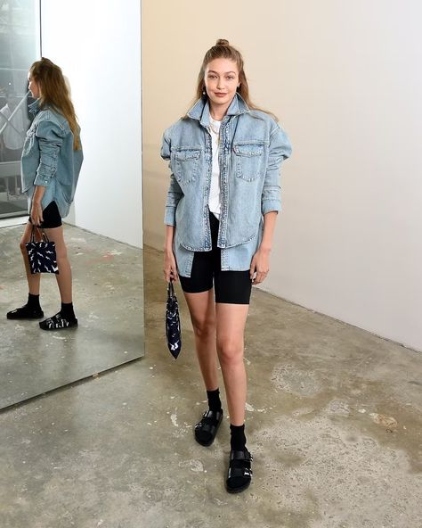 Leave it to the eldest Hadid for a simple yet impactful take on Birkenstocks that's worth recreating. Start with your go-to basic biker shorts, a white tee, and a pair of athletic socks. Then layer a boxy denim jacket over a chambray button-down and, voilà, a supermodel-approved outfit. Hadid’s favorite pair of shoes are from the Valentino x Birkenstock collab Birkenstocks With Socks, Sandals With Socks, Bike Shorts Outfit, 90s Inspired Outfits, Black Biker Shorts, Sock Outfits, Dad Fashion, Fashion Shoes Flats, Double Denim