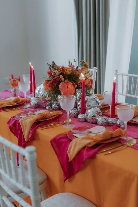 Stylish Pink & Orange Wedding Tablescape Groovy Wedding Table Decor, Pink And Orange Wedding Nails, Pink And Orange Thanksgiving Table, Orange Tablecloth Wedding, Pink Orange Dinner Party, Pink And Orange Wedding Reception, Orange Table Runner Wedding, Orange Pink And Red Wedding, Pink And Orange Hens Theme