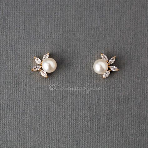 An off-white pearl sits next to four leaf CZ jewels in these pretty stud earrings for the bride. The earring measurements are .75 inches long and 3/8 inches wide, rhodium, rose gold, or gold plated, AAA CZ, lead, and nickel free. Second Stud Earrings, Second Stud, Small Earrings Gold, Earrings Bride, Gold Earrings Models, Fashion Terms, Ear Ring, Bride Jewelry, Aesthetic Jewelry