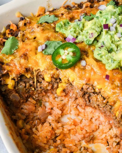 In this Mexican Casserole Recipe, zesty rice, refried beans, and seasoned ground beef are layered together, topped with cheese and baked. A delicious meal that's easy to make from scratch, or the perfect way to enjoy taco night leftovers! Beef Rice Taco Casserole, Refried Beans And Rice Casserole, Meals With Refried Beans Dinners, Ground Turkey Refried Beans Recipes, Mexican Casserole With Refried Beans, Taco Casserole Bake With Rice, Taco Casserole With Refried Beans, Mexican Casserole With Beef And Rice, Mexican Noodle Casserole