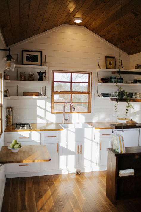 The kitchen has open shelving, custom steel brackets, a farmhouse sink, and butcher block countertops. Tiny Home Kitchen, Tiny Farmhouse, Tiny House Builders, Small Tiny House, Wind River, Best Tiny House, Farmhouse Kitchen Cabinets, Tiny Home Ideas, Tiny House Kitchen