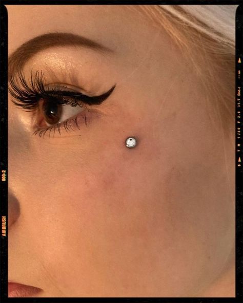 Piercing On Cheekbone, Simple Face Piercings, Face Cheek Piercing, Anti Brow Piercing Aesthetic, Dermal Piercing Face Cheek, Eyebrow Dermal Piercing, Upper Cheek Piercing, Anti Eyebrow Piercing Dermal, Microdermal Piercing Face Anti Eyebrow