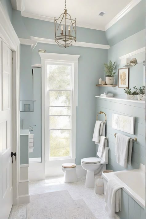 Dive into the daily routine of an interior designer as they create a coastal modern bathroom... Light Blue Wainscoting Bathroom, Wherein Williams Bathroom Colors, Blue Ocean Bathroom, Pale Blue Bathroom Cabinets, Bathroom With Light Blue Walls, Light Blue Paint For Bathroom, Sw Lullaby Paint Bathroom, Sw Topsail Bathroom, Bathroom Bright Colors