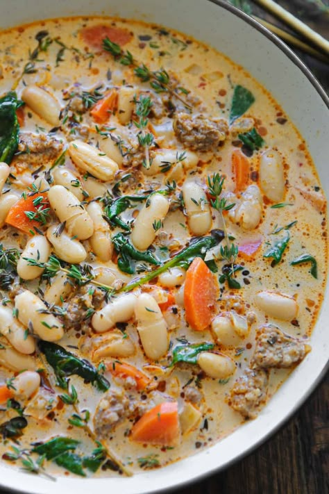 sausage white bean soup with carrots and spinach - in a white bowl. Sausage White Bean Soup, Sausage White Bean, Simple Spinach Salad, Soup With Spinach, Soups And Chilis, Sausage Soup Recipes, Sausage Tortellini, Italian Sausage Soup, Hamburger Casserole