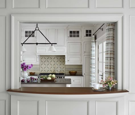 This serving window connects the kitchen to the dining and living room. A concealed pocket door separates the kitchen from the living space while food is being prepared. #paneledwalls #woodcountertop #whitekitchencabinets #passthroughwindow #colonialstylearchitecture #traditionalarchitecture Pass Through Window Kitchen To Living, Pass Through Window Kitchen, Kitchen Hatch, Kitchen Pass Through Window, Half Wall Kitchen, Serving Hatch, Pass Through Kitchen, Kitchen Pass Through, Kitchen Pass