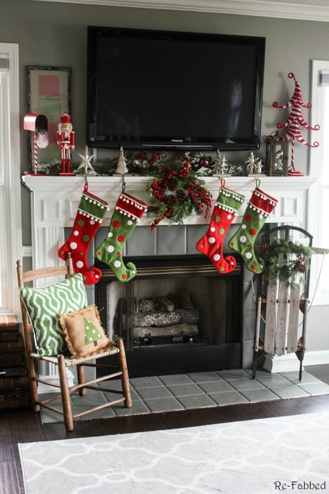 One of the biggest challenges in home decorating is how to decorate your mantel with a TV. This post highlights several different ideas on how to do just that! Must pin to remember this one. How To Decorate Mantle With Tv Above It For Christmas, Christmas Mantle Decor With Tv, Christmas Fireplace Design, Christmas Fireplace Ideas, Christmas Fireplace Decorations, Decorating A Mantel, Christmas Mantel Ideas, Diy Christmas Fireplace, Christmas Mantles