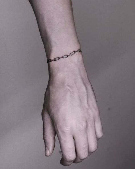 Chain bracelet tattoos are a popular choice for both men and women. Find inspiration for your next tattoo with these 52 unique designs. #chainbracelettattoo #bracelettattoo . #Chain_Bracelet_Tattoo_Wrist #Chain_Tattoo_Design_For_Women #Bracelet_Hand_Tattoo #Mens_Bracelet_Tattoo Hand Tattoo Bracelet, Chain Bracelet Tattoo Wrist, Bracelets Tattoo Men, Red Line Wrist Tattoo, Simple Chain Tattoo, Mens Bracelet Tattoo, Men Bracelet Tattoo, Wrist Chain Tattoo, Cuff Tattoo Men