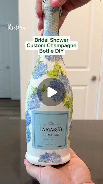 PureWow on Instagram: "Looking for a fun bridal shower idea? 🤍👰‍♀️ Gift the bride-to-be a DIY custom champagne bottle. 🍾

#DIY #customchampagnebottle #DIYchampagnebottle #bridalshowerideas #bridalshower #bridalshowergift" Diy Prosecco Bottle, Mod Podge Champagne Bottle With Napkins, Painting Prosecco Bottles, Bridal Champagne Bottle, Midge Podge Champagne Bottle, Customized Champagne Bottle, Custom Painted Champagne Bottle, Decorative Champagne Bottles, Bride Champagne Bottle