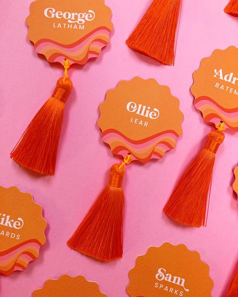 This wedding day set is all coming together 👏 🍊 It’s the Still Into You design, customised for G + C in pinks, tans and shades of orange. Very cool 😎 ___ Images are of wavy circle place cards with a retro wavy pattern in alternating shades of brown, yellow and orange. Each place card has a bright orange tassel, and the cards lay on pink card. • • • #weddingplacecards #escortcards #placecards #weddingtablescape #weddingtable #weddingbreakfast #weddingstationery #weddingmenu #retrowedding #... Wedding Name Cards Colorful, Retro Table Decor, Pink Orange Yellow, Pink And Orange Wedding, Orange And Pink Wedding, Wedding Place Names, Wedding Name Cards, Kids Labels, Bright Wedding