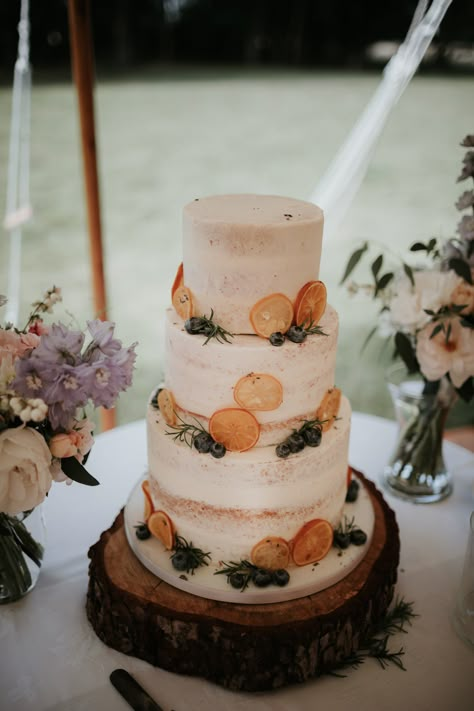 Semi-Naked Wedding Cake on Rustic Stand With Orange Slice Decor Wedding Cake With Orange Slices, Cake Rustic, Wedding Cake With Oranges, Wedding Cakes Homemade, Simple Cottagecore Wedding Cake, Simple Homemade Wedding Cake, Orange Slice Wedding Cake, Dried Orange Wedding Cake, Orange Cake Wedding