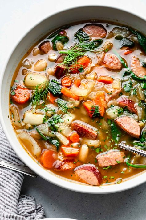 This easy Kielbasa Soup recipe is filled with savory sausage, hearty potatoes, and healthy vegetables. It’s a warm and comforting soup that’s perfect for a cold winter day. // recipes healthy // Turkey Kielbasa Recipes, Soup With Beans, Kielbasa Soup, Kielbasa And Potatoes, Lentil Sausage Soup, Sausage Soup Recipes, Kielbasa Recipes, Kielbasa Sausage, Comforting Soup