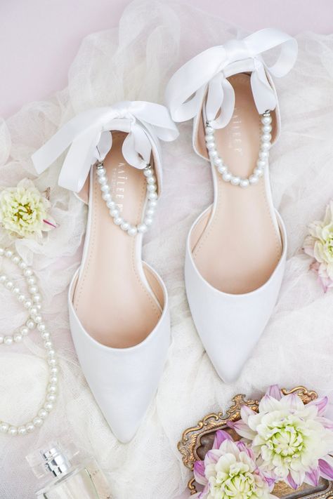 "Satin pointy toe flats with beautiful row of pearls as ankle strap. Comfortable throughout your special day and perfect for holiday party, night out and wedding party. YOU CAN CHOOSE THE PEARLS ANKLE STRAP AT CHECKOUT Details: COLORS AVAILABLE: Black, Burgundy, Champagne, Dusty Pink, Hunter Green, Ivory, Light Blue, Navy, Red, Royal Blue, Silver, and White UPPER: Synthetic upper and lining MATERIALS: Manmade outsole Heel height: 0.625\" STYLE NAME: BELLA SIZE FIT: RUNS LARGE, ORDER HALF SIZE DO Bride Shoes Flats, Wedding Flats For Bride, Bride Flats, Wedding Shoes Women, Satin Wedding Shoes, White Bridal Shoes, Shoes Bride, Bridal Flats, Wedding Shoes Bride