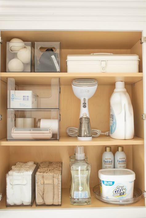 Minimal Laundry Room Organization, Laundry Cabinet Storage, Laundry Cabinet Organization Ideas, Hair Dryer And Curling Iron Storage, Aesthetic Laundry Organization, Laundry Room Cupboard Organization, Laundry Ideas Organization, Bath Salt Storage Ideas, Laundry Room Organization Modern