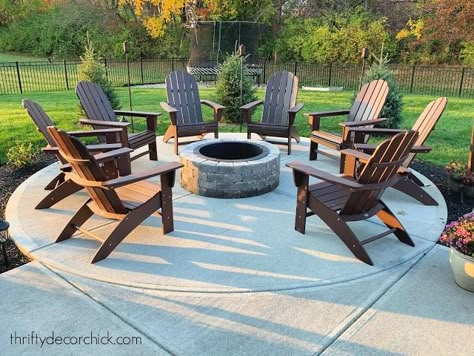 Backyard Round Fire Pit Ideas, Patio Ideas For Mobile Home, Adirondack Chairs Around Fire Pit, Concrete Patio Fire Pit Ideas, Poolside Fire Pit Ideas, Fire Pit On Concrete Patio, Concrete Patio Ideas With Fire Pit, Outdoor Fire Pit Area Ideas, Furniture Around Fire Pit