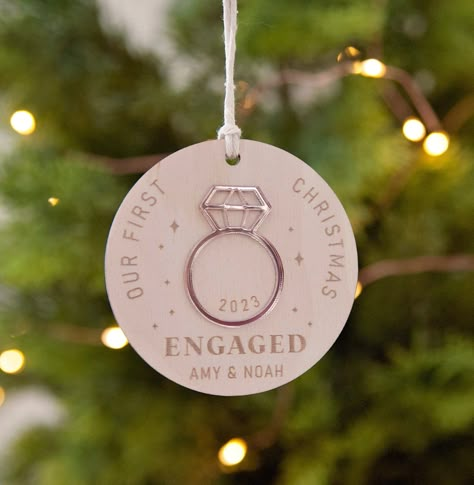 Our beautiful keepsake ornaments are the perfect gift to celebrate your First Christmas as an engaged couple - a wonderful beginning to your new chapter. The ornament is approximately 3 inches wide and is laser-cut in-house.  ----------------------------------- PRODUCT DETAILS: * Available in wood or clear acrylic * The ring is in mirrored rose gold acrylic (this is for both wood or clear ornament) * Wood grain will vary with each piece * Each comes with a natural twine ready to be hung on your Cricut Engagement Projects, Laser Wood Ornaments, Laser Ornaments Christmas, Laser Gift Ideas, Couples Gifts Diy, Engaged Ornament Diy, Laser Cut Christmas Ornaments, Laser Cut Gifts, Laser Ornaments