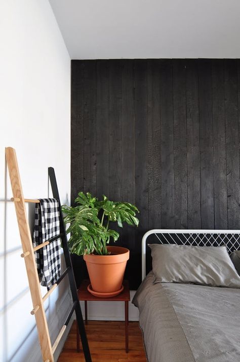 A New Twist on the Matte Black Trend | From the exteriors of houses to furniture to kitchen cabinets and more, one of the most popular ways to add matte black to your home is the easy and versatile accent wall. Want to take your matte black game to the next level though? Get the Shou Sugi Ban Look on Your Walls. Montreal Apartment, Black Accent Walls, Painting Wood Paneling, Chips Ahoy, Charred Wood, Wood Accent Wall, Apartment House, Bedroom Decorating Ideas, Bedroom Decorating