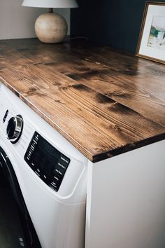 Tabletop For Washer And Dryer, Diy Shelf On Top Of Washer And Dryer, Board On Top Of Washer And Dryer, Washer And Dryer Table Top, Washer Dryer Folding Counter, Wooden Shelf Above Washer And Dryer, Washer And Dryer With Countertop, Wood Above Washer And Dryer, Quick Laundry Room Makeover