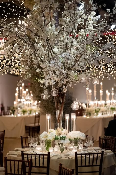 This Candlelit Winter Wedding in Brooklyn Was an Elegant Baby’s Breath Dream - Green Wedding Shoes Tall Winter Centerpieces For Table, Elegant Winter Wedding Centerpieces, Winter Wedding Isles, Winter White Wedding Decor, Tall Winter Centerpieces, January Wedding Decor, Winter Wedding Floral Centerpieces, Wedding Decor White And Green, Winter Wedding Decorations Elegant