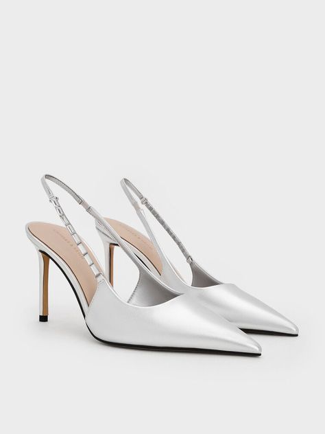 These silver pumps will take you from the office to after-dark events with ease. The sleek pointed-toe design looks especially polished in silver, while the embellishments on the straps add a glamorous touch. Sitting on slender stiletto heels, they will elongate your frame too. Silver Pumps, Slingback Pump, Toe Designs, After Dark, Stiletto Heels, The Office, Pumps, Sleek, Heels