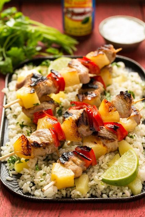 This recipe for pork kabobs with pineapple is tender chunks of marinated pork, skewered with pineapple and bell pepper and grilled to perfection. Pork Kebabs, Pork Kabobs, Spicy Pineapple, Pineapple Pork, Cilantro Rice, Marinated Pork Tenderloins, Pork Loin Recipes, Rice Dinner, Tenderloin Recipes