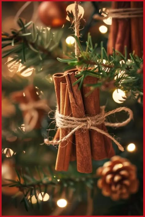 Cinnamon sticks tied with twine hanging on a Christmas tree. Handmade Christmas Baskets, Organic Christmas Ornaments, Woodland Ornaments Diy Rustic Christmas, Rustic Christmas Tree Ornament, Christmas Tree Inspiration Natural, Christmas Organic Decoration, Natural Tree Ornaments Diy, Natural Christmas Tree Decorations Rustic, Rustic Christmas Ornaments Diy Homemade