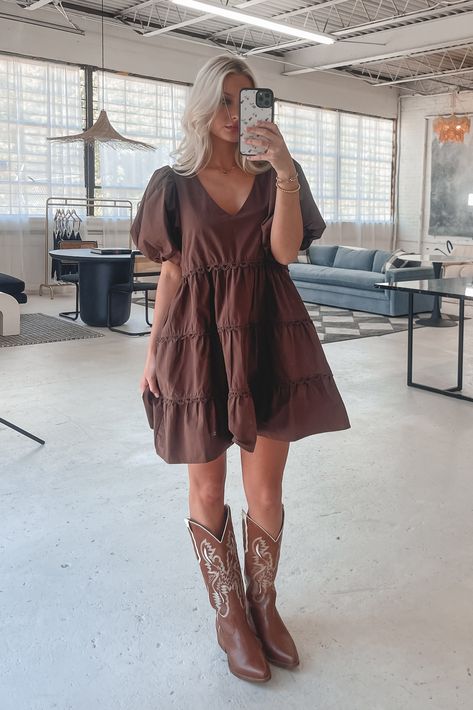 A day in the life of a fashion icon because you in this dress is stunning!!! Dark brown short puff mini dress, tiered style, dress is lined Material is Polyester Hang to dry Model is 5’7 wearing a small SHOP THE LOOK Small Medium Large Length 30” 31” 32” Bust 18” 19” 20” Brown Babydoll Dress, Toffee Outfits, Overal Dress, Short Dress Cowboy Boots, Dress For A Country Concert, Dress With Brown Cowboy Boots, Western Dress Ideas, Brown Fall Dress, Country Cocktail Attire