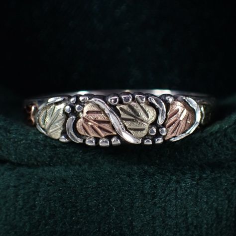 This beautiful little treasure is a sterling silver & 12K black hills gold stacker style ring. It features the well known black hills gold tri-color grape and leaf design. The setting measures approx. 3/16" tall. It's a size 8 and weighs 1.88 grams. #vintagejewelry #vintage #sterlingsilver #blackhillsgold #grape #leaf #stacker #pinky #ring #nostalgia #justlisted #purchasenow #sawdustfinery #familybusiness #womeninbusiness #smallbusiness #shopsmall #etsyseller #etsy Black Hills Gold Rings Vintage, Gold Rings Vintage, Black Hills Gold Rings, Grape Leaf, Black Hills Gold, Black Hills, Pinky Ring, Tri Color, Leaf Design