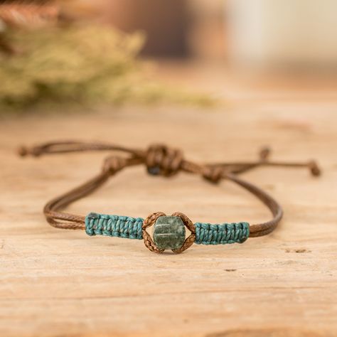 The star of the show in this fashionable men's bracelet is a captivating dark green jade pendant that takes center stage with its exotic allure. Expertly accented with intricate waxed cotton macrame detailing in a vibrant teal hue, Guatemalan artisans Erick and Ivania's impressive design seamlessly fuses tradition and contemporary flair. Its adjustable brown nylon cord ensures a tailored fit, allowing you to wear this accessory with ease and comfort. Chinese Cord Bracelets, Diy Jewelry For Men, Bracelets With Embroidery Thread, Macrame Bracelet Patterns Easy, Macrame For Men, Diy Macrame Bracelet Tutorial, Easy Bracelet Patterns, Handmade Bracelets For Men, Boho Bracelets Tutorial