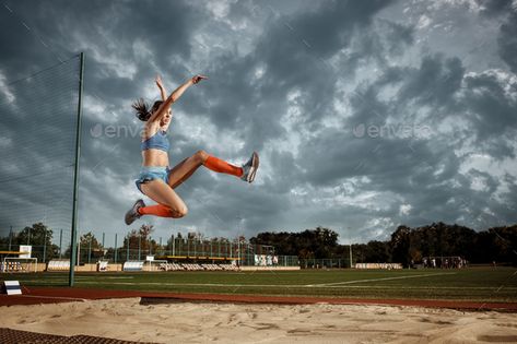 Female athlete performing a long jump during a competition by master1305. Female athlete performing a long jump during a competition at stadium. The jump, athlete, action, motion, sport, succ...#long, #jump, #competition, #Female Long Jump Aesthetic, Jump Aesthetic, Athletics Aesthetic, Field Photo Ideas, 100m Hurdles, Track Photos, Sports Portraits, Triple Jump, Sport Portraits