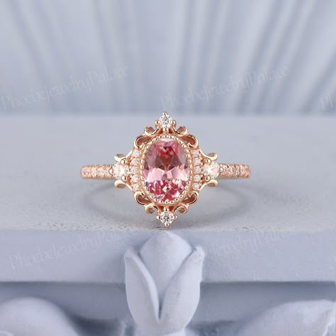 Vintage Peach Pink Sapphire Engagement Ring Oval Wedding Rings for Women Solid Gold Diamond Cluster Cocktail Ring Anniversary Handmade Gift PRODUCT SUMMARY Metal Type: yellow, white or rose solid 10k, 14k or 18k gold. Size: All sizes are available, contact me if they do not contain the size you want in the drop-down menu. ☪☪Engagement ring ⚜Center Stone - Lab Grown Peach Pink Sapphire Cut - Oval Size - 5x7mm ⚜Side Stone - Moissanite or Natural Diamond Cut - Round Weight - 0.21ct Clarity - SI-VS Oval Pink Sapphire Ring, Colored Gemstone Engagement Rings, Pink Engagement Rings, Oval Wedding Rings, Pink Diamond Wedding Rings, Sapphire Engagement Ring Oval, Wedding Rings Pink Sapphire, Peach Sapphire Rings, Oval Sapphire Engagement Ring