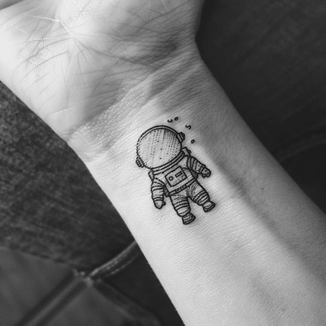 Embrace the universe on your skin with this minimalist astronaut tattoo, a symbol of adventure and the vastness of human curiosity. Save this cosmic inspiration and follow for more celestial wonders. This delicate ink captures the explorer within us all, nudging us towards the stars. Perfect for those who dream of interstellar journeys and the mysteries beyond our world. 🚀✨ #SpaceTattoo #MinimalistInk #AstronautArt #CelestialBeauty #InkInspiration #AI Small Spaceman Tattoo, Small Astronaut Tattoo Simple, Astronaut Sitting On Moon Tattoo, Spaceman Tattoo Simple, Astronaut Tattoo Minimalist, Interstellar Tattoo Minimalist, Mini Astronaut Tattoo, Simple Astronaut Tattoo, Small Astronaut Tattoo