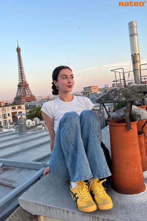 A girl sitting on a rooftop in Paris with the Eiffel Tower in the background wearing Onitsuka Tiger Mexico 66 Yellow Black Trainers Retro Sneakers Aesthetic, Onitsuka Tiger Tokuten Women Outfit, Yellow Tiger Shoes Outfit, Styling Yellow Shoes, Yellow Mexico 66 Outfit, Onitsuka Tiger Street Style, Onitsuka Tiger Yellow Women Outfit, Yellow Tiger Shoes, Cool Trainers Women