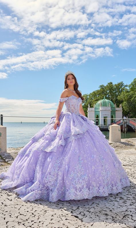 Pastel off the shoulder quinceanera a-line ball gown with layered skirt and lace embroidered flowers. Moda 2000 Quinceanera Dresses, Quinceanera Dresses Lavender, Lilac Quinceanera Dresses, Lavender Quinceanera Dresses, Lavender Quinceanera, Quince Dresses Purple, Purple Quince, Quinceanera Themes Dresses, Purple Quinceanera Dresses