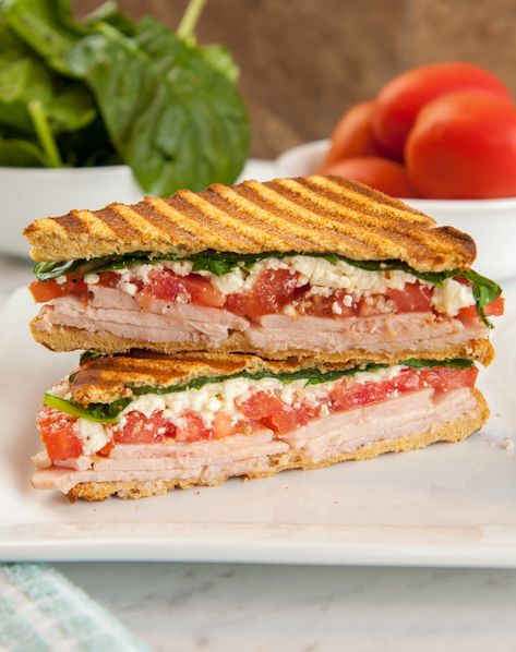 This grilled sandwich combines the delicious flavors of feta cheese, tomatoes, spinach, turkey, and garlic aioli, in a tasty Mediterranean-style. Layer it all between slices of Martin’s Whole Wheat Potato Bread and grill it in a panini press for a warm, crisp crust. Sandwiches are easy to make and easy to pack, making them great school lunches! Turkey Panini Sandwiches, Turkey Panini Recipes, Mediterranean Sandwich, Sandwich Recipes Panini, Turkey Panini, Turkey Sandwiches Recipes, Salad Art, Mediterranean Recipe, Healthy Sandwich