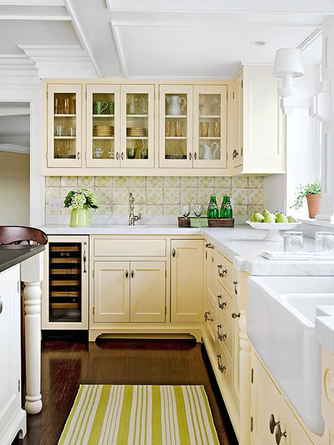 Sweetly Nostalgic Color Scheme -  Evoking nostalgia, this kitchen recalls simpler times  (I'd change the green out and go with blue; but I like the butter-cream color on the cabinets!) Colored Kitchen Cabinets, Cream Colored Kitchens, Cream Colored Kitchen Cabinets, Kitchen Cabinet Color Schemes, Yellow Kitchens, Yellow Kitchen Cabinets, Cream Kitchen Cabinets, Colored Kitchen, Yellow Cabinets