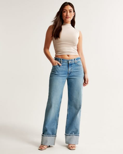 Our Curve Love low rise baggy jeans in a medium wash with a cuffed hem. This fit features a 8.5” low rise, is slightly relaxed at waist and hips, and eases at the thigh into a baggy, full-length leg shape. We recommend buying your true size for a baggier fit. Size down for a closer fit. The viral fit that eliminates waist gap: Curve Love features additional room through the hip and thigh for curve-hugging comfort. This jean is made from our vintage stretch fabric which features both an authentic Abercrombie And Fitch Outfit, Low Rise Baggy Jeans, Baggy Jean, Abercrombie Jeans, Love Jeans, Cuffed Jeans, Jeans For Short Women, Baggy Fits, Baggy Jeans