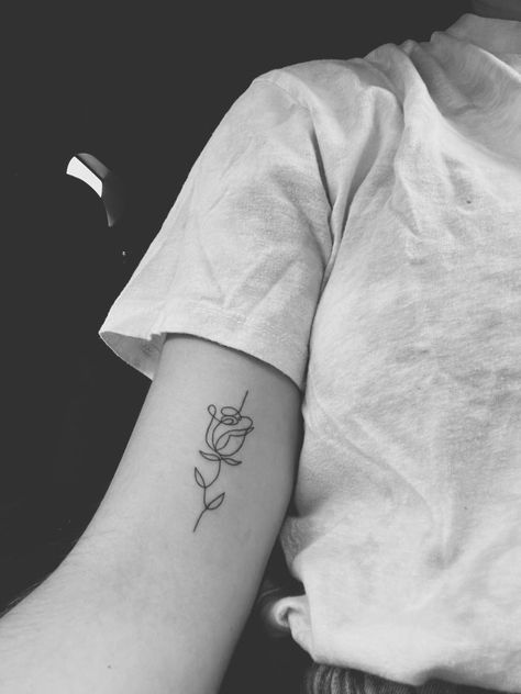 Simple Rose Tattoo With Words, Simple Rose And Butterfly Tattoo, Modern Rose Tattoo Design, Back Of Arm Rose Tattoo, Rose Cursive Tattoo, Scribble Rose Tattoo, Script Rose Tattoo, Rose Line Drawing Tattoo, Simple Rose Outline Tattoo