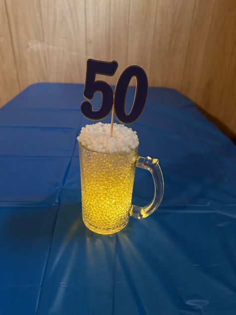 Clear and white orbeez in dollar tree beer mug Beer Mug Centerpiece, Diy Beer Mug, Beer Centerpieces, Beer Theme Party, 50th Birthday Centerpieces, Diy Beer, Beer Theme, Birthday Centerpieces, 50th Party