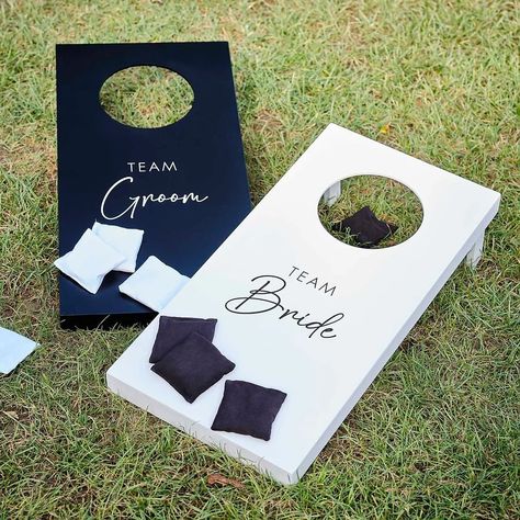 Have some fun with this cornhole wedding day game on your special day. 🤍🖤 It’s the perfect way to get the party started with your wedding guests! #weddingday #weddinggames #cornhole #cornholeboards #bridevsgroom #lawngames #gardenparty #wedding #weddinginspiration #weddinggarden #weddingideas Yard Games For Wedding Receptions, Games For Market Day, Backyard Wedding Cornhole, Wedding Outdoor Activities, Modern Rustic Wedding Decor Receptions, Cornhole For Wedding, Wedding Activities For Guests Indoor, Mr And Mrs Cornhole Boards, Backyard Black And White Wedding