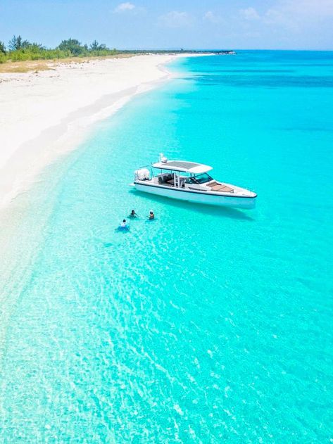 Boat floating in the clear turquoise water of the Caribbean sea off the coast of Turks and Caicos Turks And Caicos Vacation, Private Boat, Island Pictures, Travel Inspiration Destinations, Senior Trip, Dream Travel Destinations, Incredible Places, Boat Trips, Beautiful Places To Travel