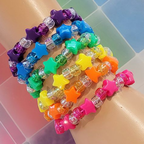 These kandi bracelets are made with rainbow,glitter pony beads and cute star beads. These measure 7 inches. Includeds 6 kandi bracelets one in each color. This Item is made to order. Perfect for any event! You will get lots of compliments in this unique wearable art! Stand out at your next event! Edm festival  Raves Party  Rave outfit  Festival outfit Pride Party favor Birthday gift Stocking stuffer Christmas gift Glow party Rave birthday  Rave gift Rave Beads Bracelets, Star Kandi Bracelet, Kandi Star Bracelet, Candy Bead Bracelet Ideas, Pride Kandi Bracelets, Kandi Bracelets Cuff, Lots Of Bracelets On Wrist, Rave Candies, Kandi Clothing