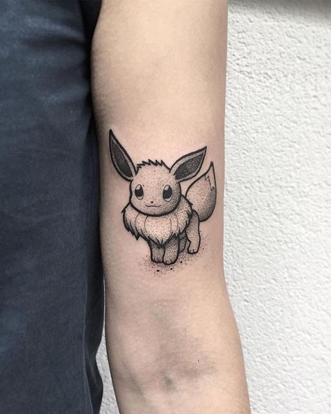 Cute Eevee tattoo by Ashtray Arts Tattoos (@ashtray_arts_tattoos) from Hamburg Germany. #STYNG - #pokemontattoo #eeveetattoo #dotworktattoo #tattoo #cutetattoo #smalltattoo #tattooideas #tattooinspiration #tattooartist Eevee Pokemon Tattoo, Eevee Tattoo, Punk Cottagecore, Pokemon Sleeves, Tattoo Zodiac, Cute Eevee, Pikachu Tattoo, Pokemon Tattoos, M Tattoos