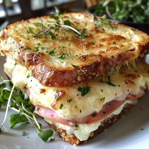 🥪🧀 Indulge in the Ultimate Croque Monsieur! 🍞✨ Enjoy a slice of French culinary heaven with this rich and cheesy Croque Monsieur. Layers of ham, Gruyère cheese, and creamy béchamel sauce toasted to perfection – it's the ultimate comfort food! 😋✨ Ingredients: White bread, butter, ham, Gruyère, Parmesan, Dijon mustard, parsley Béchamel sauce: Butter, flour, milk, nutmeg, salt, pepper Instructions: Prepare a smooth and creamy béchamel sauce. Assemble and toast the sandwiches. Top with bécham... Gourmet Ham Sandwich, French Ham Sandwich, Fresh Sandwich Ideas, Yummy Food Savory, Unique Sandwich Ideas, Ham And Butter Sandwich, Cheese And Ham Sandwich, Toasted Cheese Sandwich, French Meals