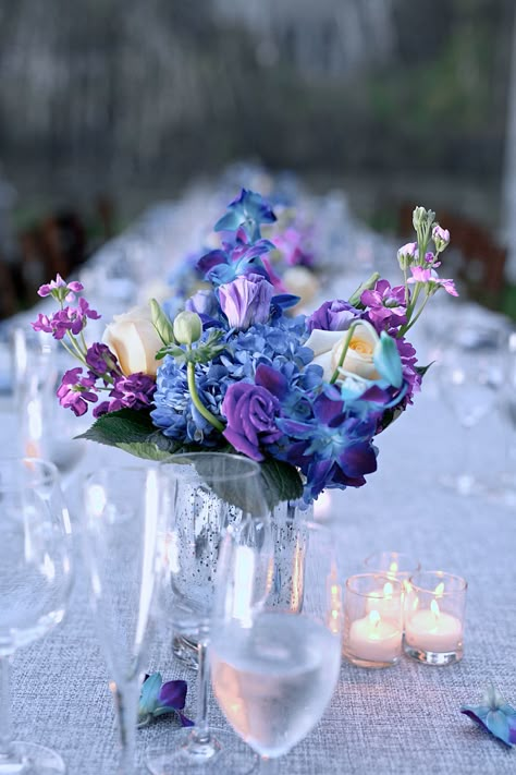 Blue and Purple Flower Centerpieces Blue Purple White Flower Arrangement, Blue Purple Party Decor, Blue Purple Fall Wedding, Blue Violet Wedding Theme, Purple Blue White Wedding Centerpieces, Purple Blue Gold Party Decorations, Purple And Blue Engagement Party, Purple Blue Centerpiece, Blue And Purple Reception Decor